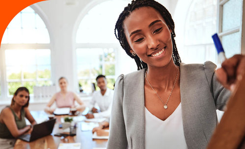 Smiling women working in a board room.