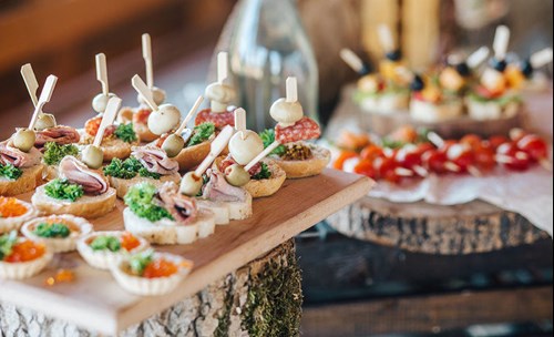 Finger foods displayed on wooden cutting boards