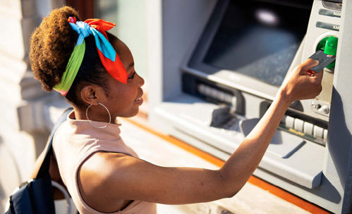 Smiling woman using an ATM