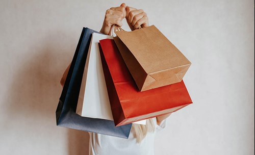 Woman holding up shopping bags