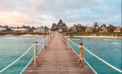 Wooden bridge over the ocean leading to an island