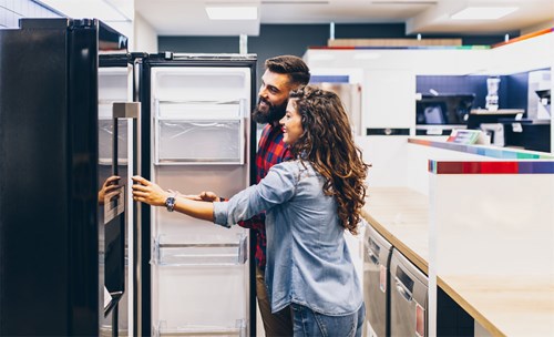 Couple looking at a fridge to buy