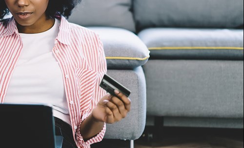 Woman sitting with a bank card