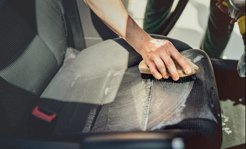 Person washing car seats