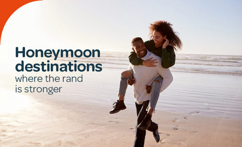 Smiling couple on the beach, man piggy-backing woman