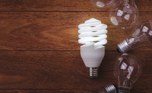 Different types of light bulbs on a wooden table