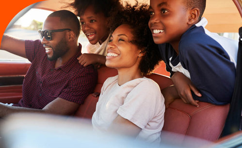 Laughing family in car.