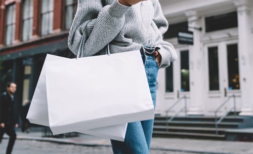 Woman walking in the street with shopping bags