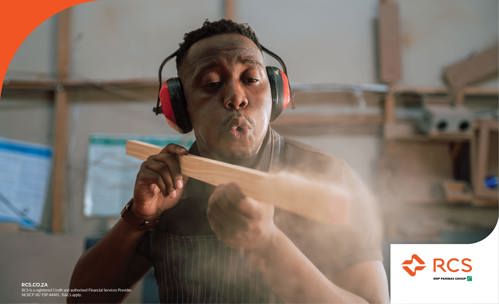 Man blowing sawdust from a piece of wood