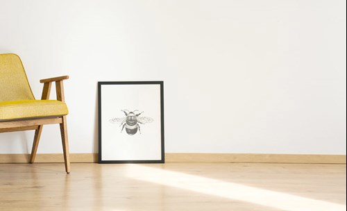 Chair, artwork on wooden floor