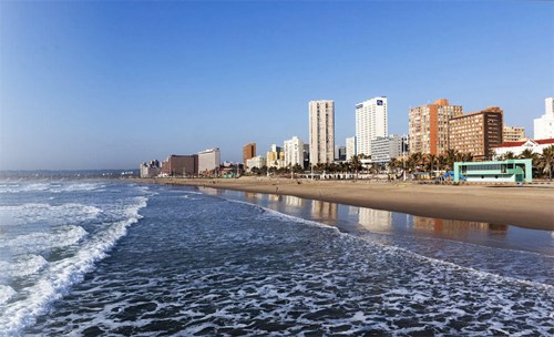 Beach and ocean with a city landscape background