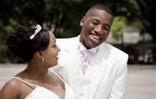 Bride and groom laughing with each other