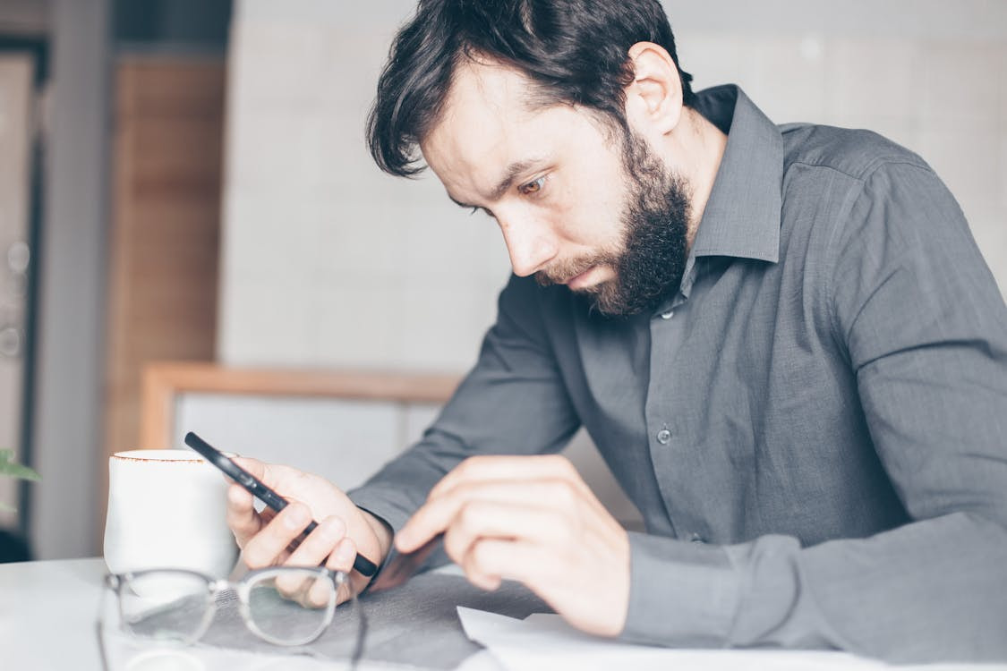 Man on his phone contacting customer service to dispute a charge on his RCS Store Card