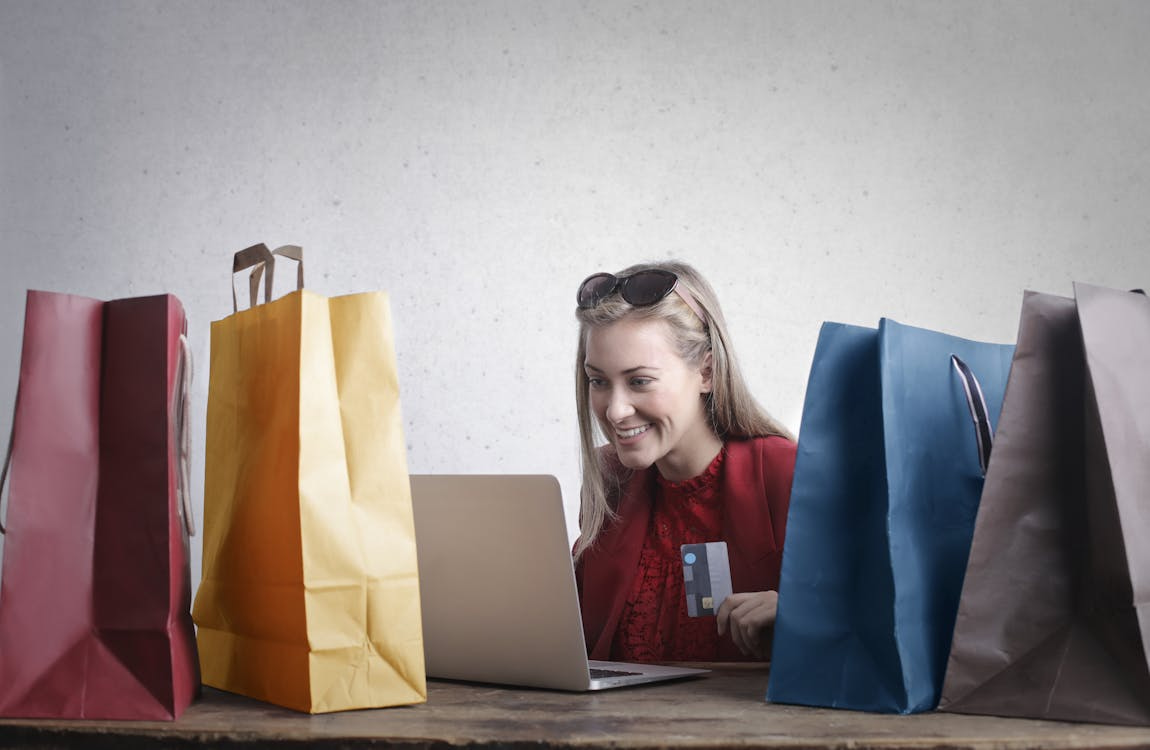 A woman enjoying online shopping with RCS cashback rewards